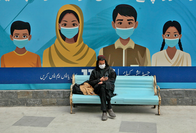 People wait their turn to receive the dose of COVID-19 vaccine at a vaccination center, in Peshawar, Pakistan, on January 21, 2022 (AP/FILE)