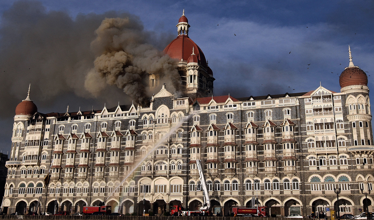 Indian firefighters attempt to put out a fire as smoke billows out of the historic Taj Mahal Hotel in Mumbai on November 27, 2008, one of the sites of attacks by gunmen. (AFP/File)