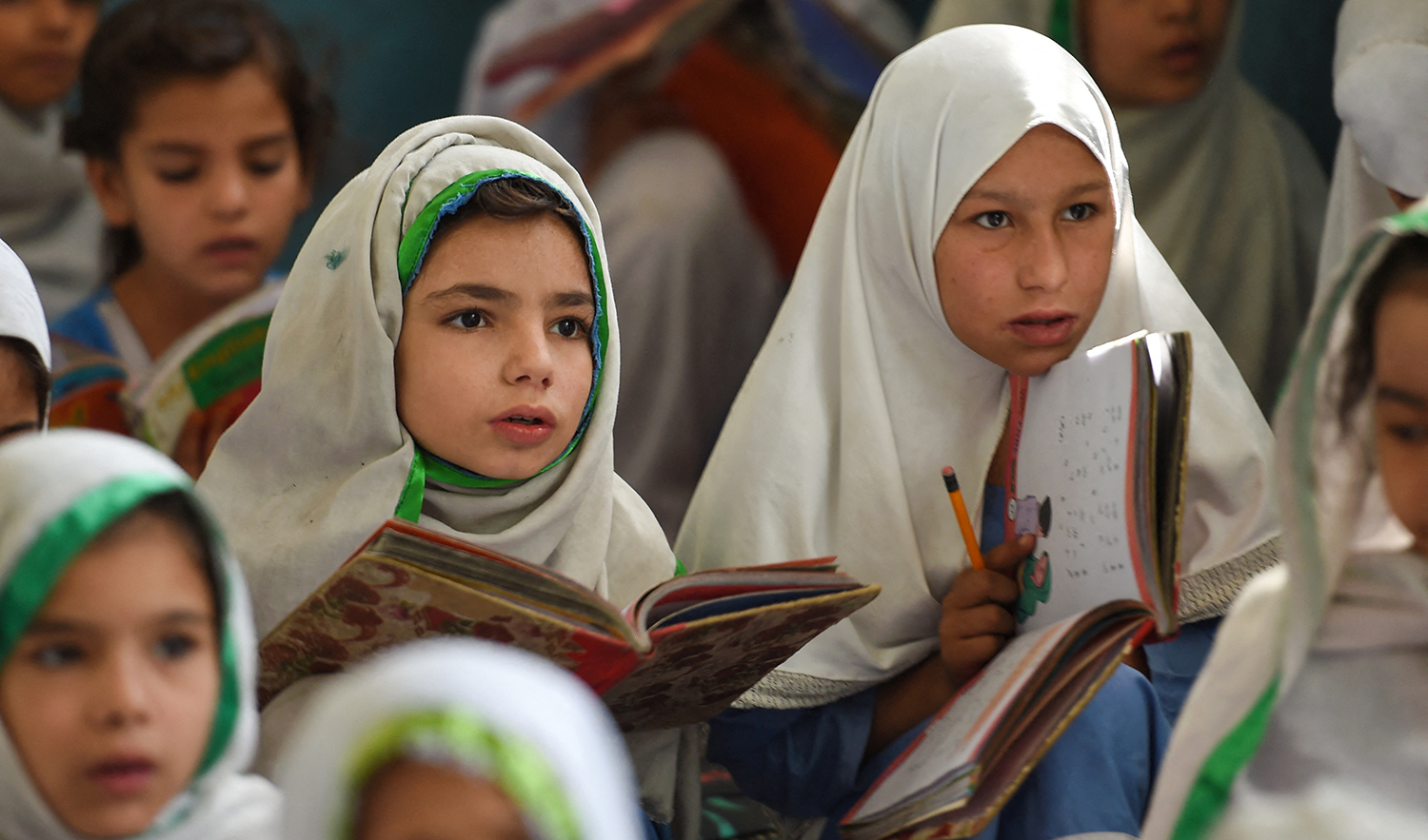 In this picture taken on September 18, 2018, girls attend a class at a school in Mingora, a town in Swat Valley, Pakistan. (AFP/File)