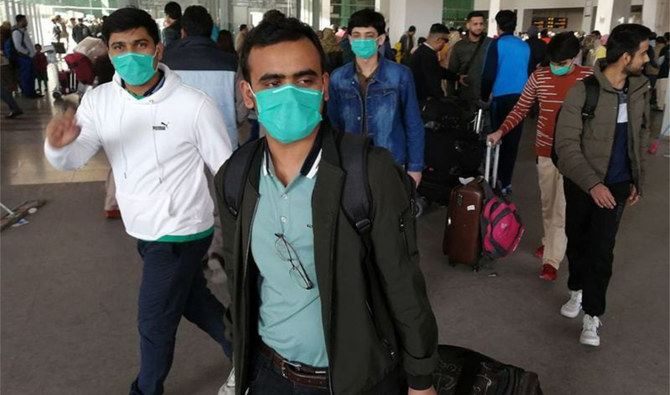Pakistani students wearing protective facemasks at the Islamabad International Airport in Islamabad on February 3, 2020. (AFP/FILE)