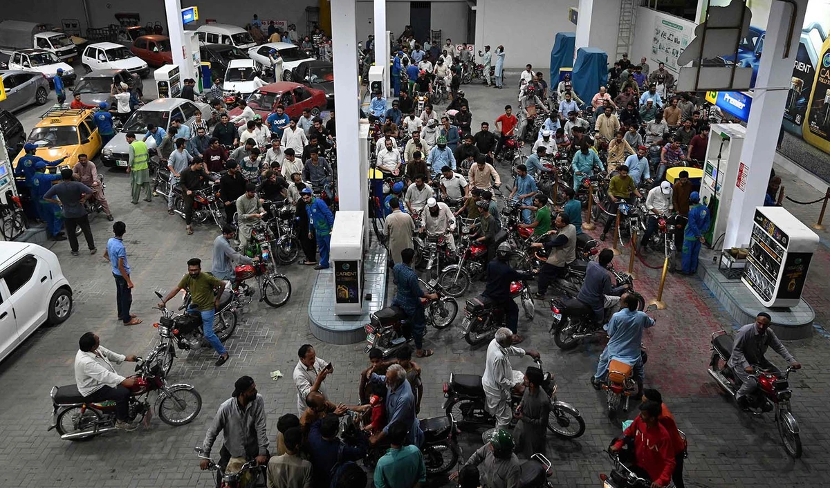 Motorists wait to fill their vehicles' tanks at a petrol station in Islamabad on June 2, 2022, following an increase of petroleum prices by the government. (AFP)