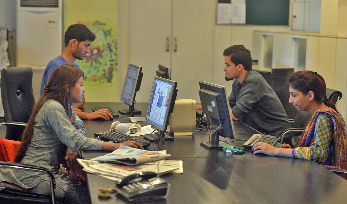 In this photograph taken on July 26, 2016, Pakistani staff of Islamabad-based Power 99 FM radio work on their computers at the radio station's office in Islamabad. (AFP/File)