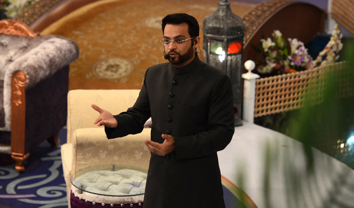 In this photograph taken on July 31, 2013, Pakistani television show host Aamir Liaquat Hussain presents an Islamic quiz show Aman Ramadan in Karachi. (AFP/File)
