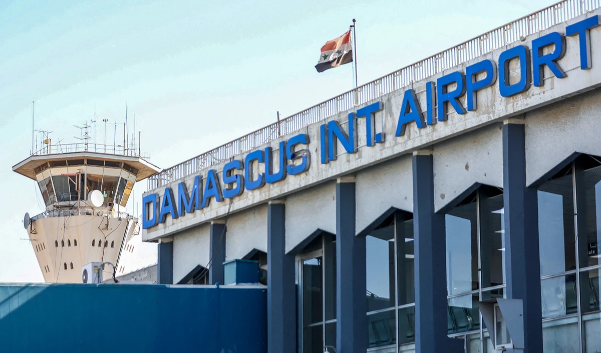 This file photo taken on October 1, 2020 shows the Syrian flag flying at Damascus International Airport outside Syria's capital. (AFP/File)