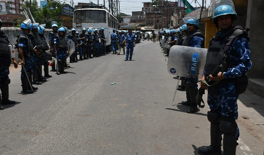 Rapid Action Force personnel stand guard along a road during a partial curfew imposed following demonstrations against former spokeswoman Nupur Sharma's remarks on the Prophet Mohammed (PBUH), in Ranchi on June 11, 2022. (AFP)