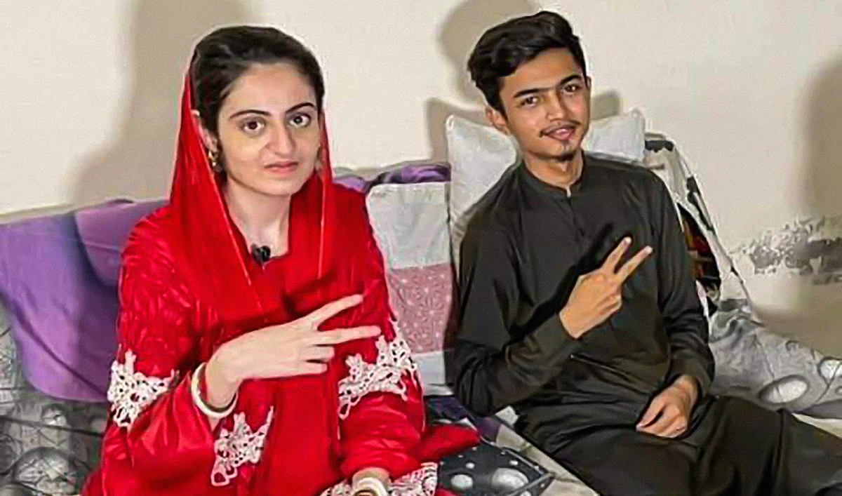 Dua Zehra, left, and her husband Zaheer Ahmed posing for a photograph during their recent interview with Pakistani YouTuber Zubair Mahum released on June 13, 2022. (Photo courtesy: Zunaira Mahum/YouTube)