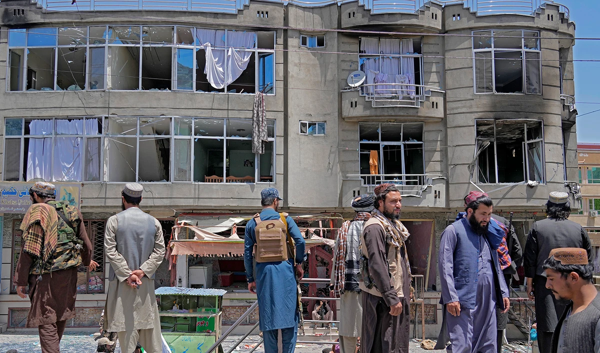 Taliban fighters stand guard at the site of an explosion in front of a Sikh temple in Kabul, Afghanistan, on June 18, 2022. (AP)