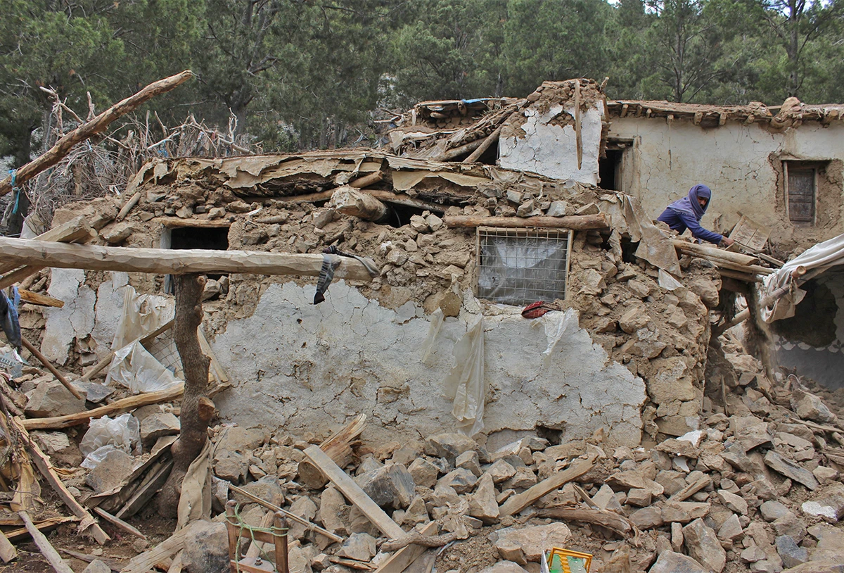 An Afghan villager collects his belongings from under the rubble of his home that was destroyed in an earthquake in the Spera District of the southwestern part of Khost Province, Afghanistan, on June 22, 2022. (AP)