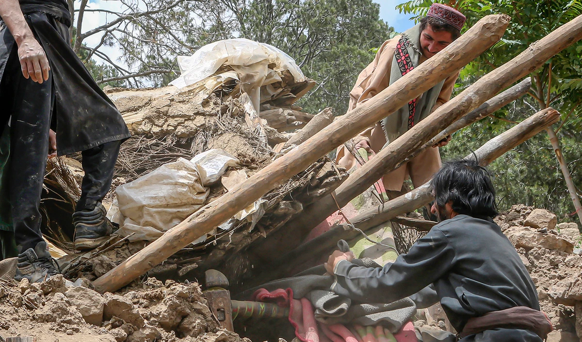 Afghan villagers collects belongings from under the rubble of a home that was destroyed in an earthquake in the Spera District of the southwestern part of Khost Province, Afghanistan, Wednesday, June 22, 2022. (AP)