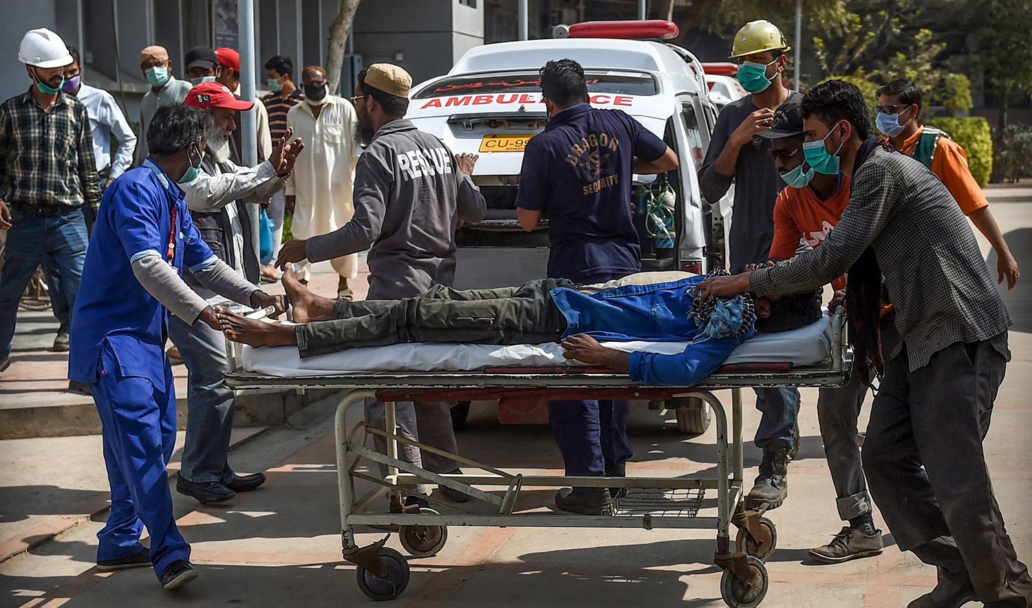 Paramedics personnel shift a patient on a stretcher into the hospital in Karachi, Pakistan, on February 18, 2020. (AFP/File)