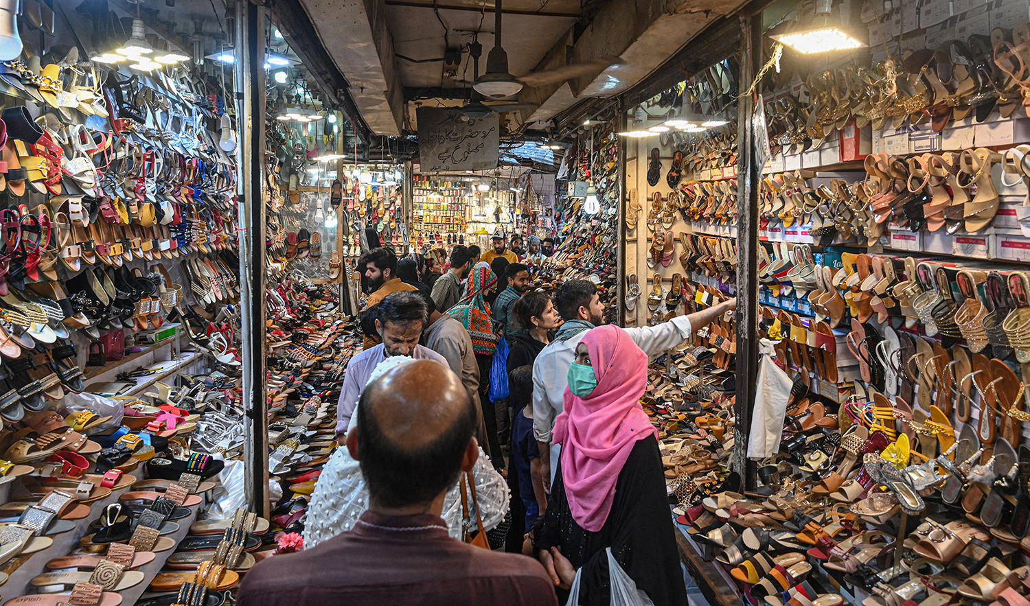 People shop at a market in Lahore, Pakistan, on April 30, 2022. (AFP/File)