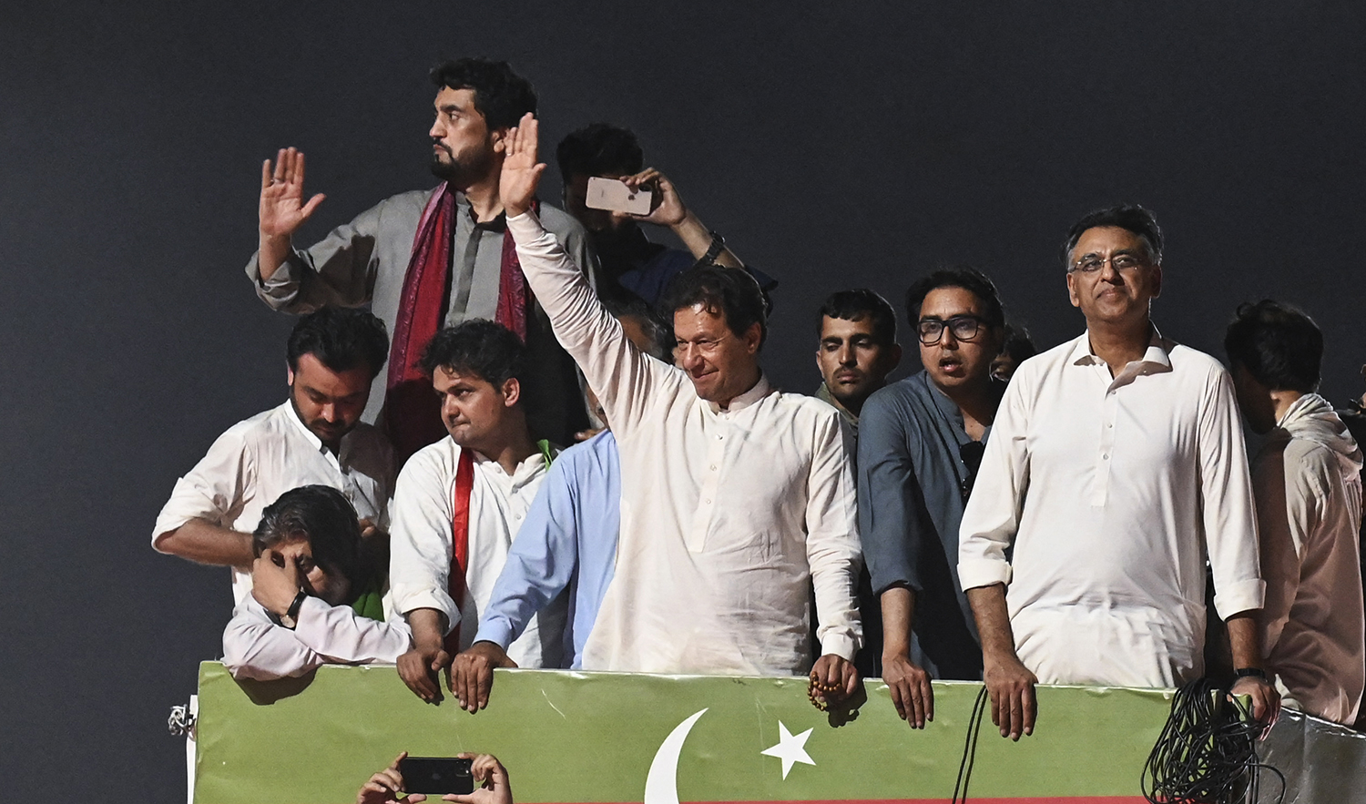 Ousted Pakistan's prime minister Imran Khan (C) waves to supporters from atop a bus as he leads a rally in Islamabad early on May 26, 2022. (AFP/File)