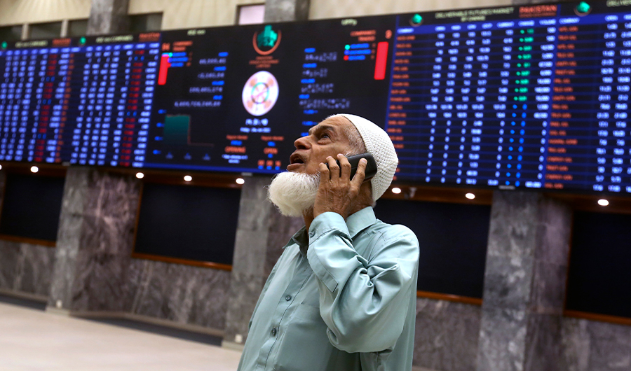 An investor monitors indexes on the big screen at the Pakistan Stock Exchange (PSE), in Karachi, Pakistan, June 24, 2022. (AP)
