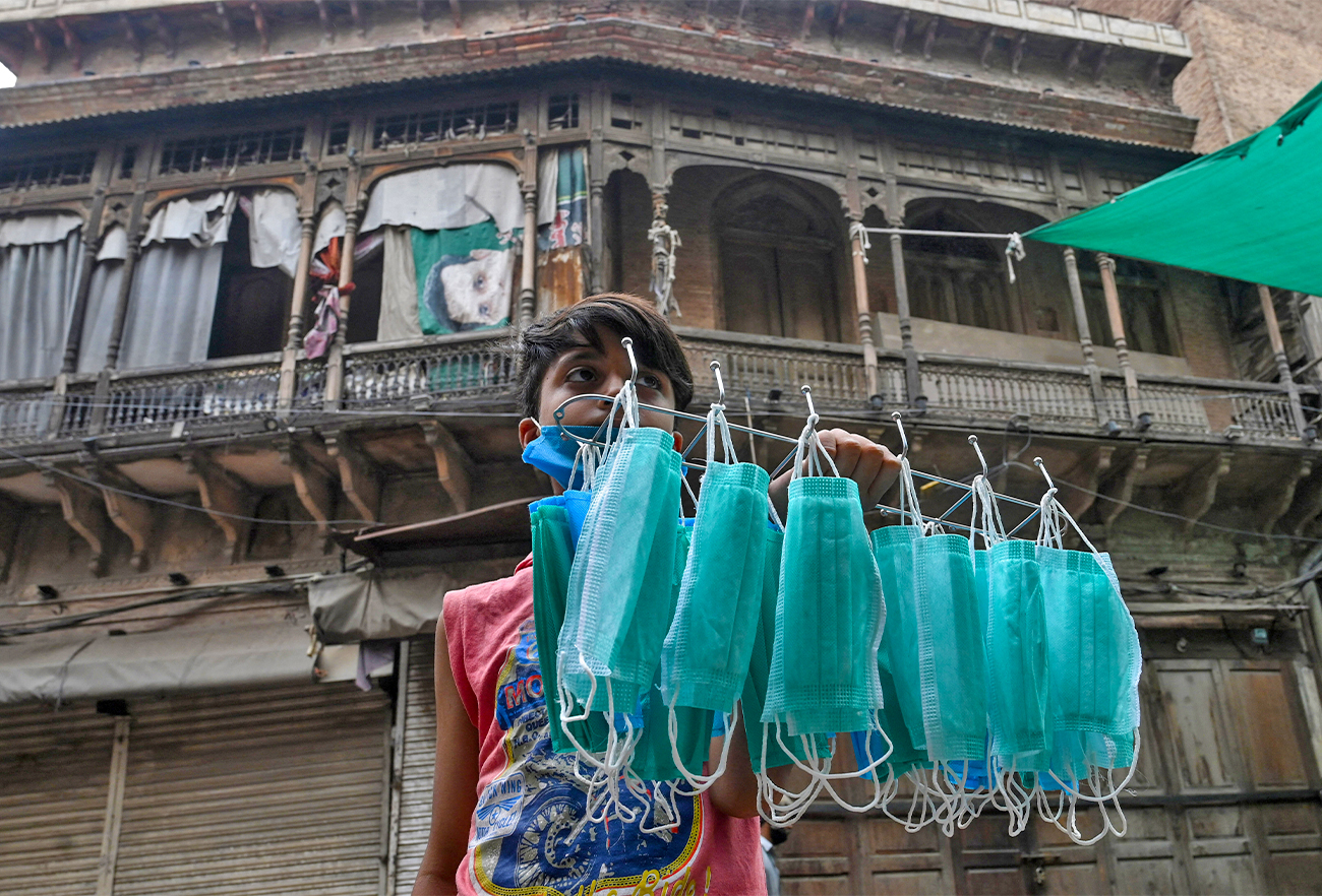 A young vendor sells facemasks on a street in Lahore, Pakistan, on June 25, 2020. (AFP/File)