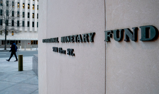 A pedestrian walks past the International Monetary Fund (IMF) headquarters in Washington, DC on January 10, 2022. (AFP/File)