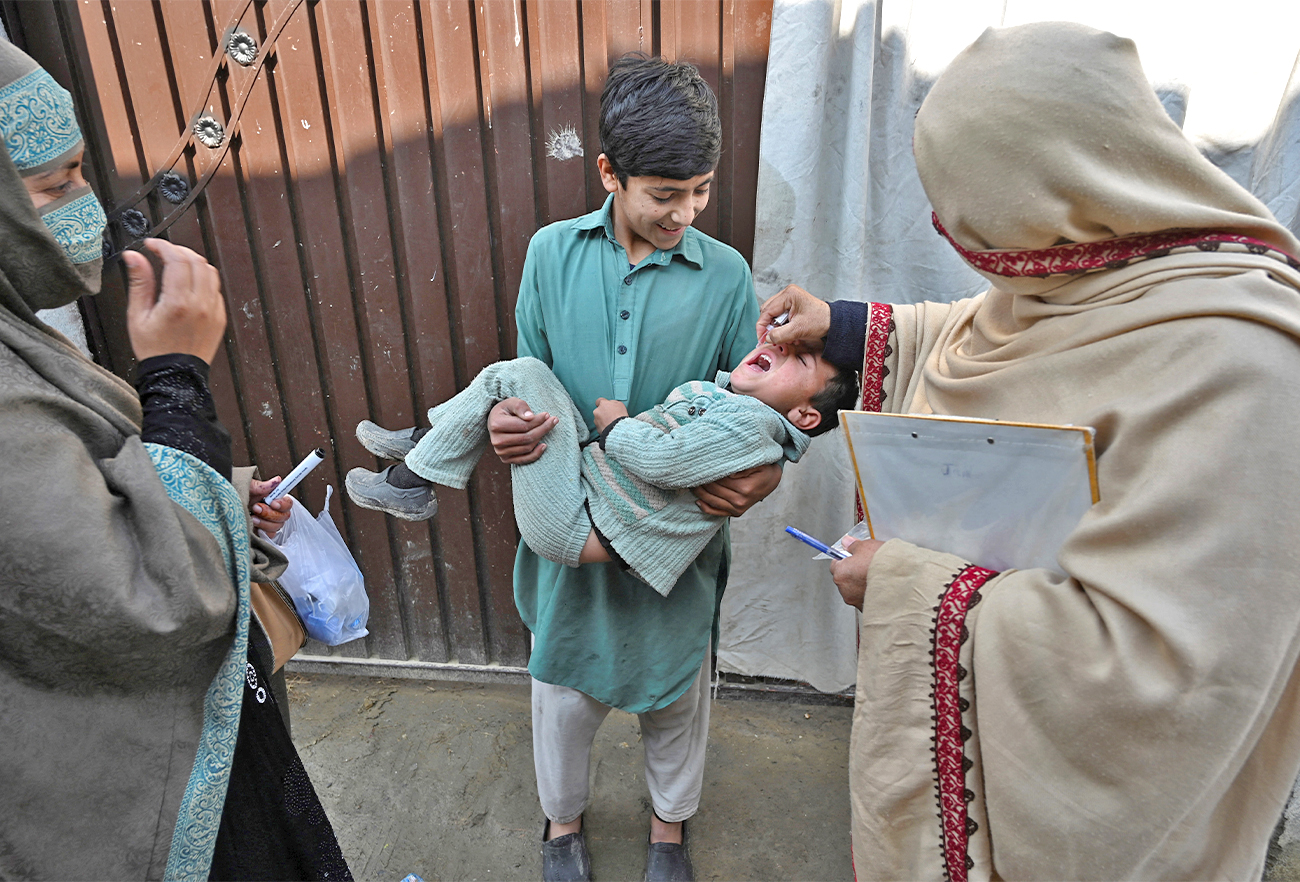 A health worker administers polio vaccine drops to a child during a polio vaccination campaign in the Pakistan's Khyber Pakhtunkhwa province on January 24, 2022. (AFP/File)