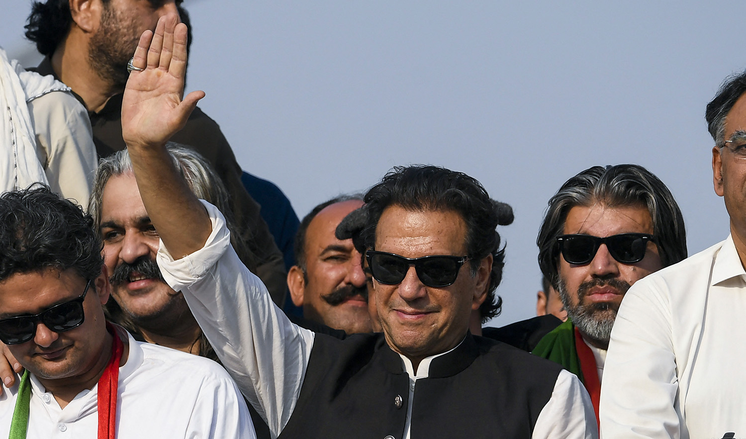 Ousted Pakistan's prime minister Imran Khan, center, waves at his party supporters during a rally in Islamabad on May 26, 2022. (AFP/File)