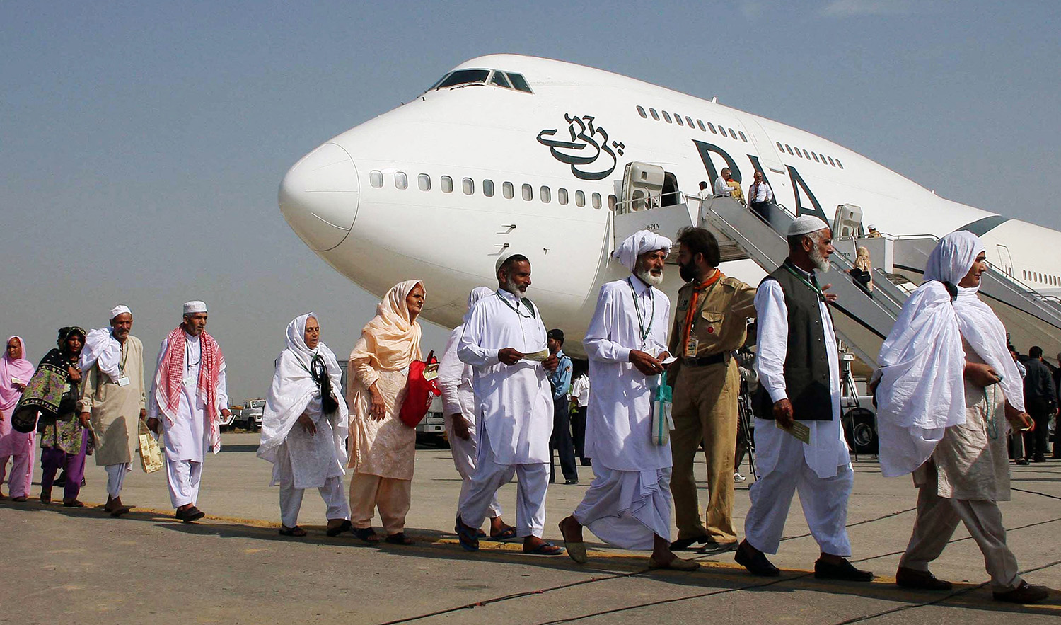 Pakistani pilgrims walk in line as they prepare to board a Pakistan International Airlines' special Hajj pilgrimage flight bound for Saudi Arabia at the Allama Iqbal International airport in Lahore on November 2, 2008. (AFP/File)