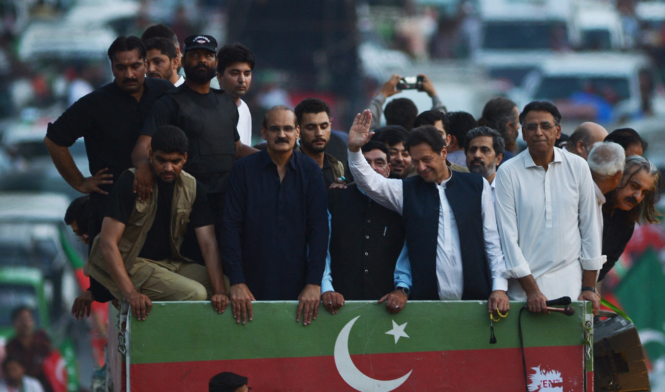 Pakistani former prime minister and PTI leader Imran Khan (front 2R) waves to supporters during a protest rally against inflation, and political destabilisation in Rawalpindi on July 2, 2022. (AFP/File)