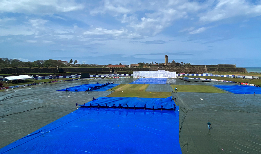 Ground staff cover the pitch as it rains during the second day play of the first cricket Test match between Sri Lanka and Pakistan at the Galle International Cricket Stadium in Galle on July 17, 2022. (AFP)