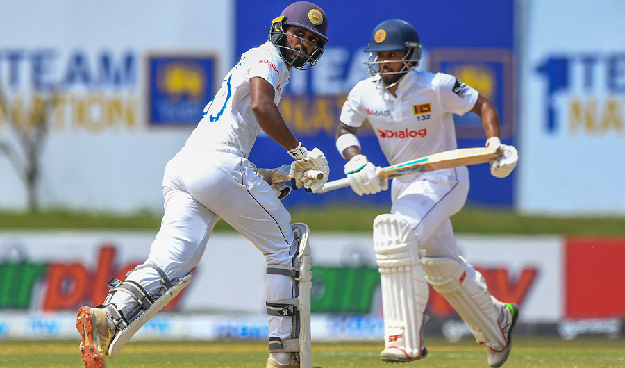 Sri Lanka's Kusal Mendis (R) and Oshada Fernando run between the wickets during the third day of play of the first cricket Test match between Sri Lanka and Pakistan in Galle on July 18, 2022. (AFP)
