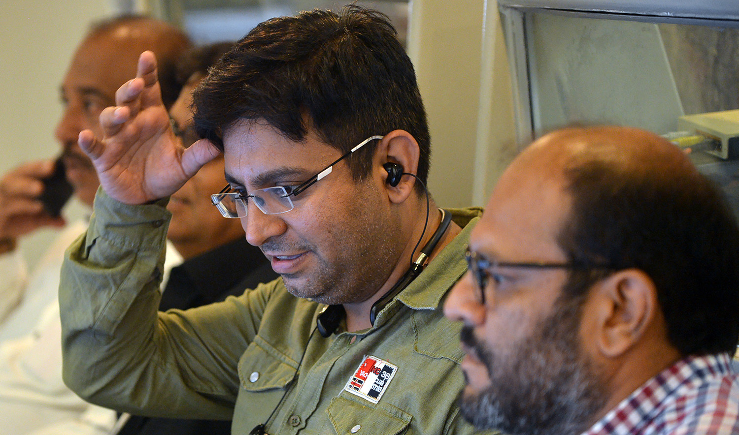 Stockbrokers monitor the latest share prices during a trading session at the Pakistan Stock Exchange (PSX) in Karachi on June 13, 2022. (AFP/File)