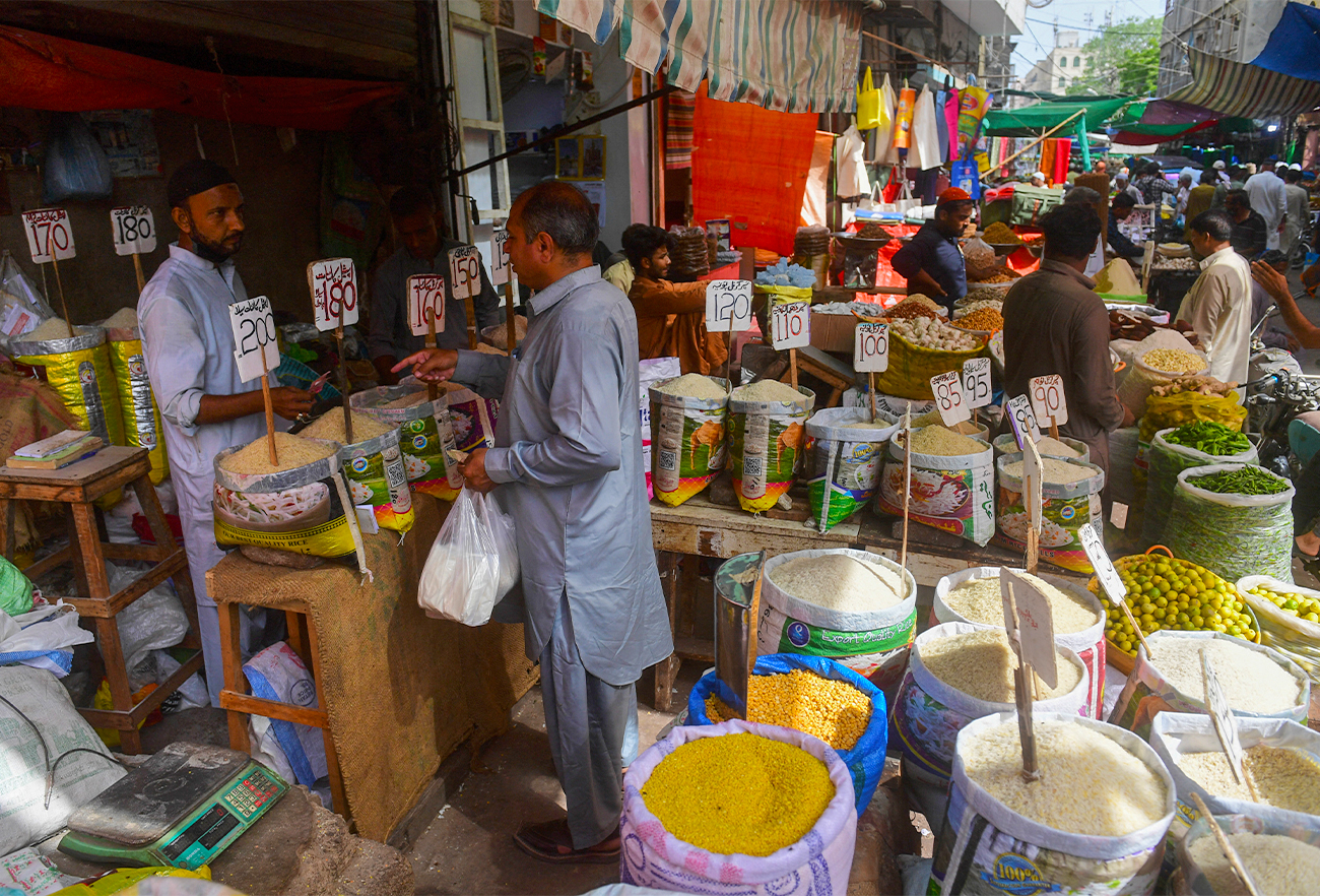 A man buys pulses at a shop in Karachi, Pakistan, on June 10, 2022. (AFP/File)
