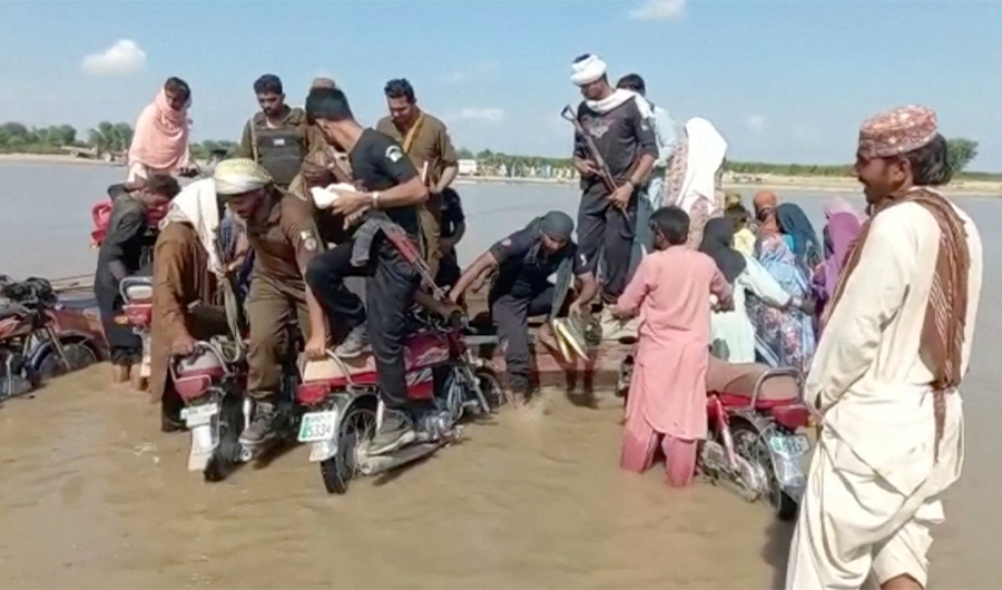 Rescuers and locals help survivors, after a boat carrying around 100 people capsized in a central Pakistani river, in Sadiqabad, Pakistan, July 18, 2022, in this still image taken from a handout video. (REUTERS)