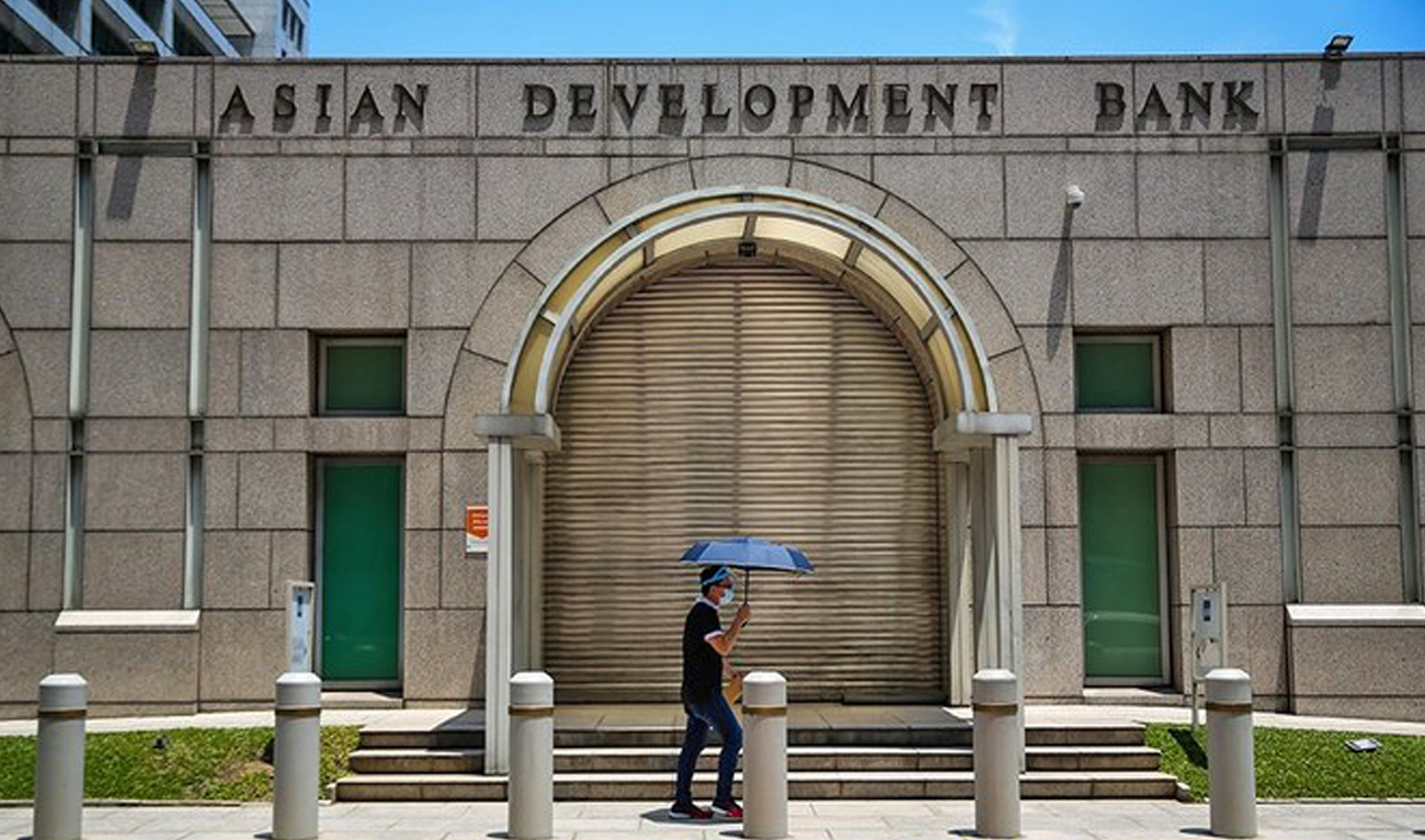 A man walks past the Asian Development Bank (ADB) building in Ortigas City, Philippines on October 8, 2021. (Reuters/File)