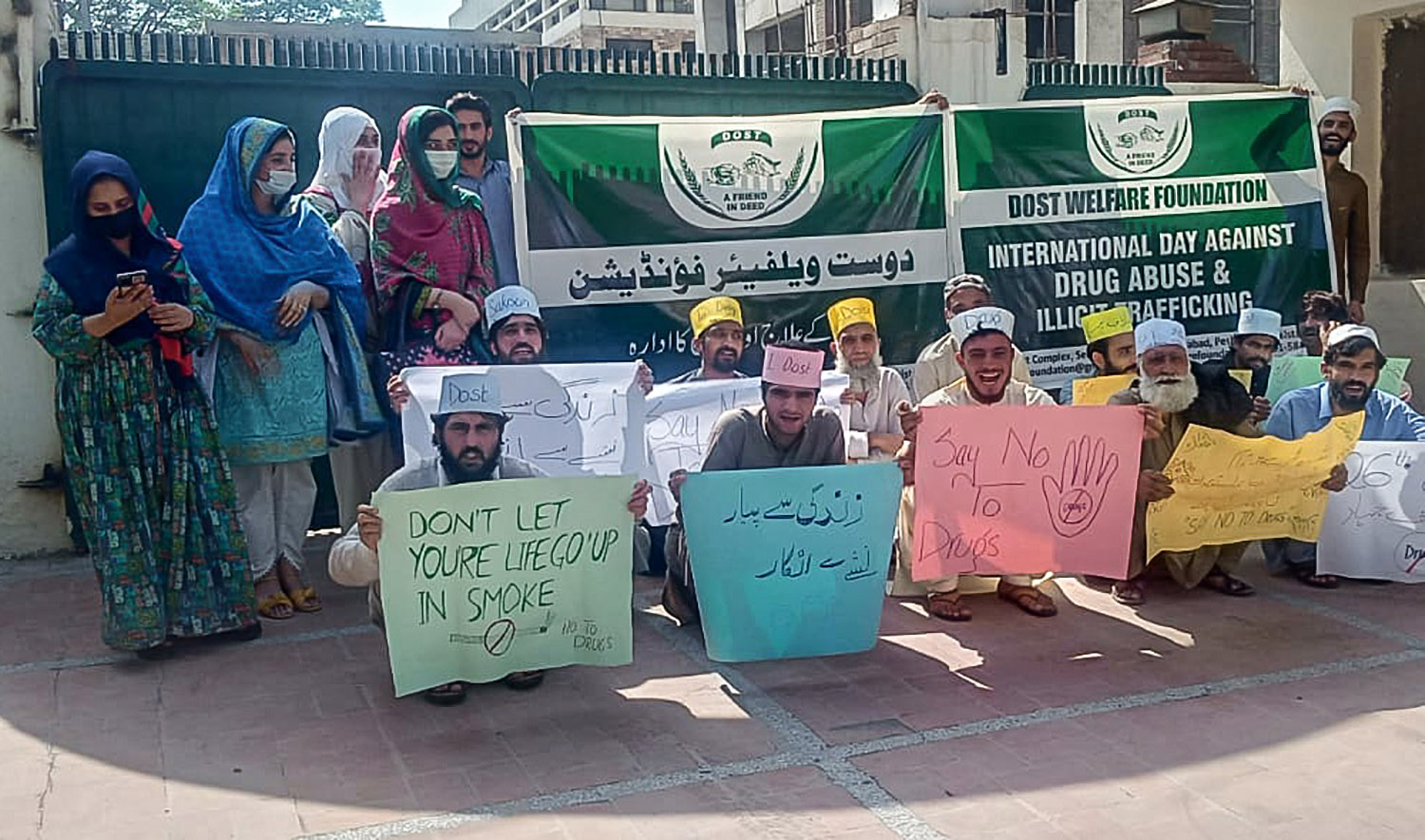 Patients undergoing a three-month rehabilitation program in Peshawar, northwest Pakistan, pose for a photo with staff members of the Dost Welfare Foundation on June 26, 2022. (Photo courtesy: Dost Welfare Foundation)