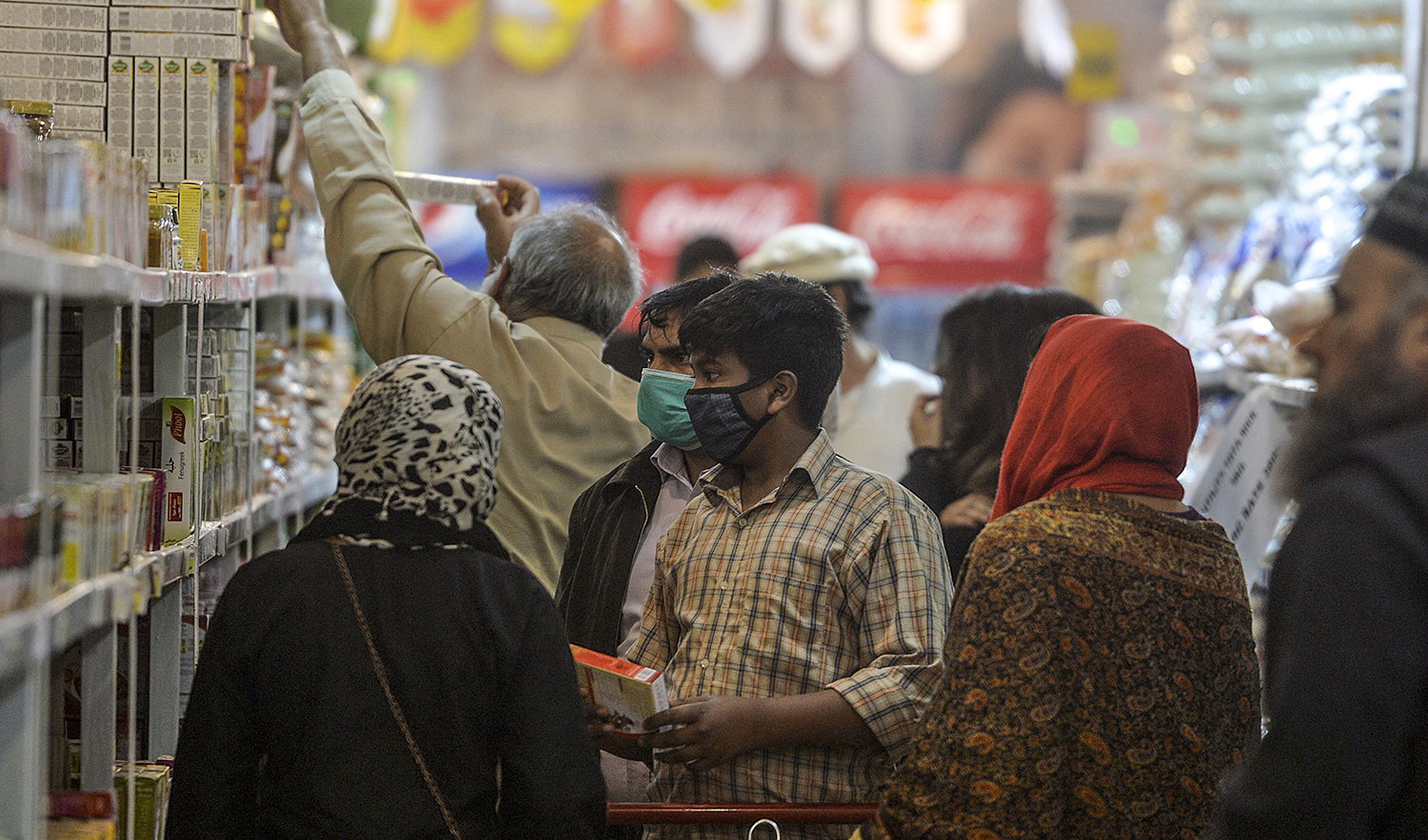 Residents buy grocery items from a utility store in Islamabad, Pakistan,on March 17, 2020. (AFP/File)