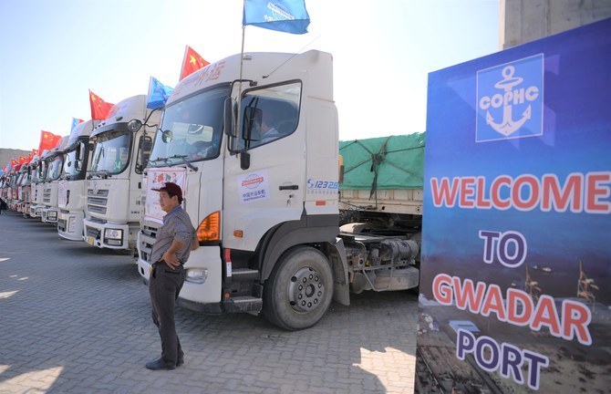 A Chinese worker stands near trucks carrying goods during the opening of a trade project in Gwadar port, some 700 kms west of the Pakistani city of Karachi on November 13, 2016. (AFP/ File)