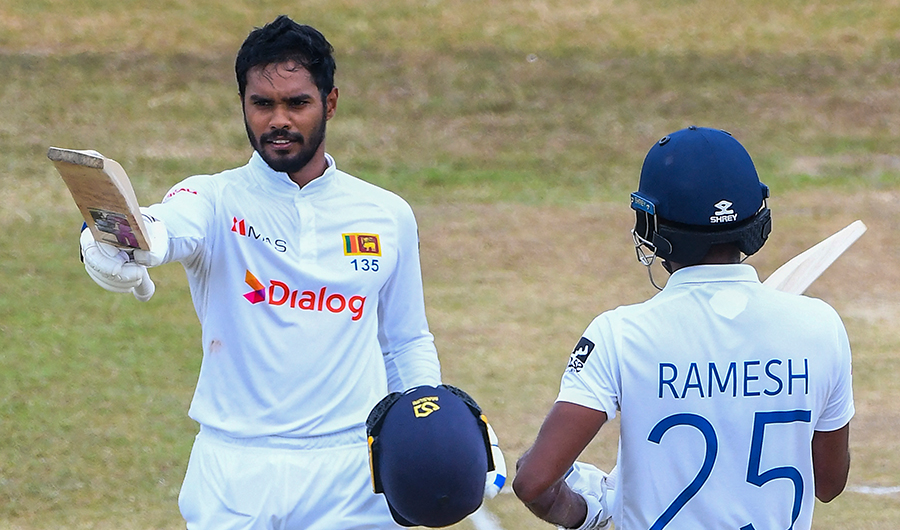 Sri Lanka's Dhananjaya de Silva (L) celebrates after scoring a century (100 runs) as his teammate Ramesh Mendis watches during the fourth day of the second cricket Test match between Sri Lanka and Pakistan in Galle on July 27, 2022. (AFP)