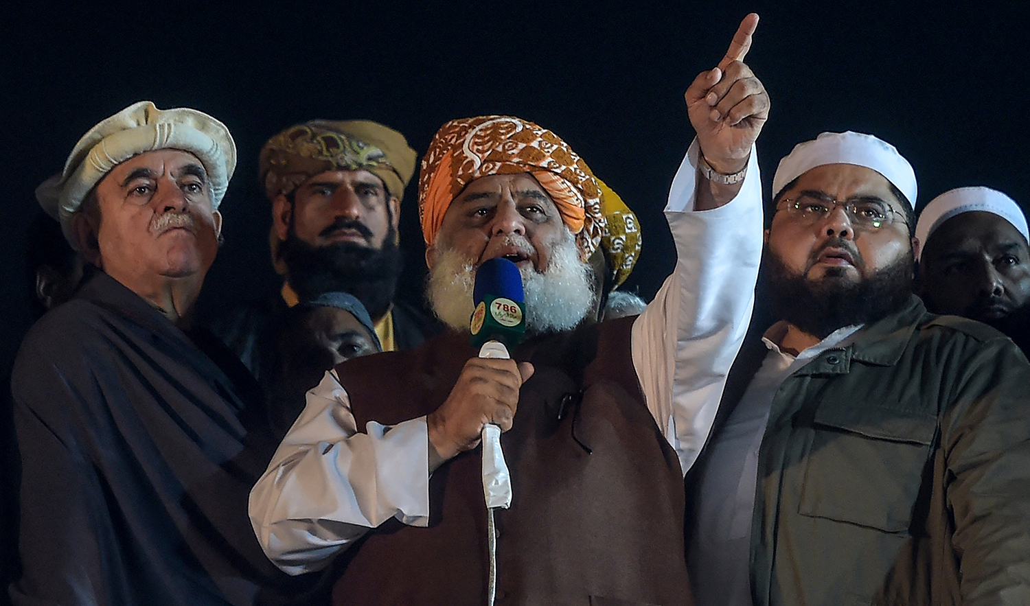 Islamic political party Jamiat Ulema-e-Islam (JUI-F) leader Maulana Fazlur Rehman, center, speaks to their supporters during a rally in Islamabad, Pakistan, on November 13, 2019. (AFP/File)