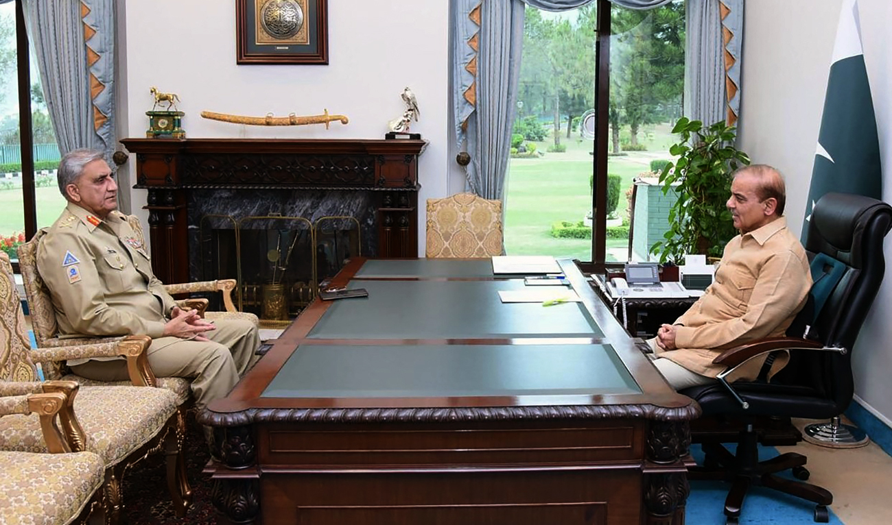 This handout photograph taken on April 19, 2022 and released by the Pakistan Prime Minister Office shows PM Shehbaz Sharif (R) speaks with Army Chief General Qamar Javed Bajwa in Islamabad. (AFP/File)
