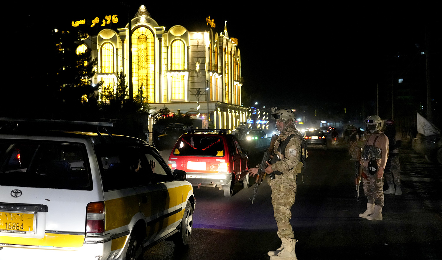 Taliban fighters stand guard at the site of an explosion in front of the Kabul International Cricket Stadium, in Kabul, Afghanistan, on July 29, 2022. (AP)