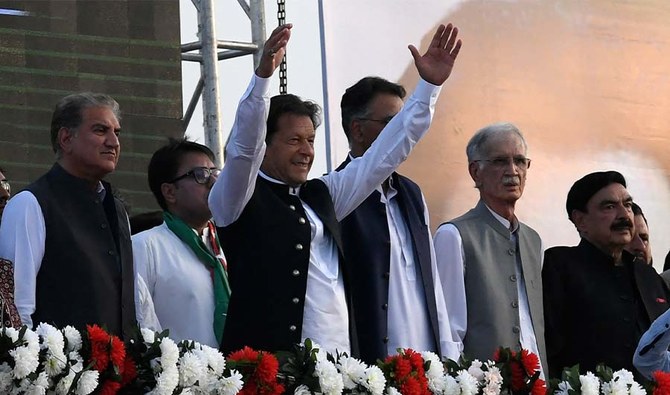 Pakistan's Prime Minister Imran Khan (C) along with other lawmakers, gestures upon his arrival to address the supporters of ruling Pakistan Tehreek-e-Insaf (PTI) party during a rally in Islamabad on March 27, 2022. (AFP/FILE)