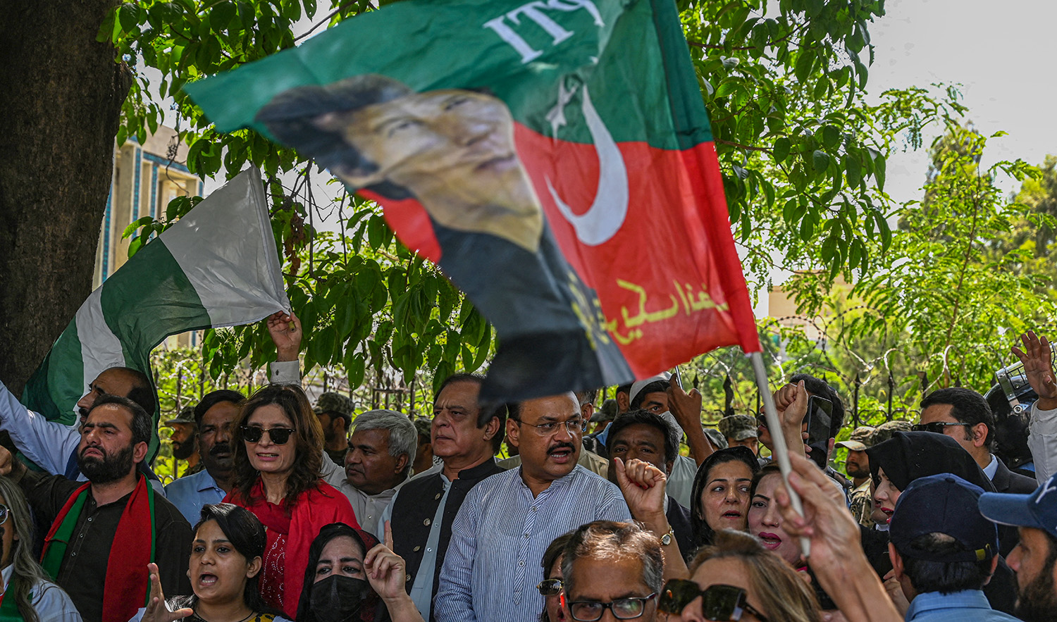 Supporters of former prime minister Imran Khan's Pakistan Tehreek-e-Insaf (PTI) party protest against the chief election commissioner, outside the Election Commission of Pakistan (ECP) office in Islamabad on April 26, 2022. (AFP/File)