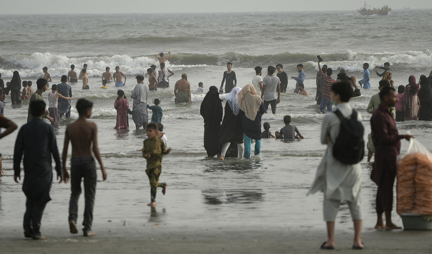 People cool off at the Clifton beach in Karachi, Pakistan, on May 5, 2022. (AFP/File)