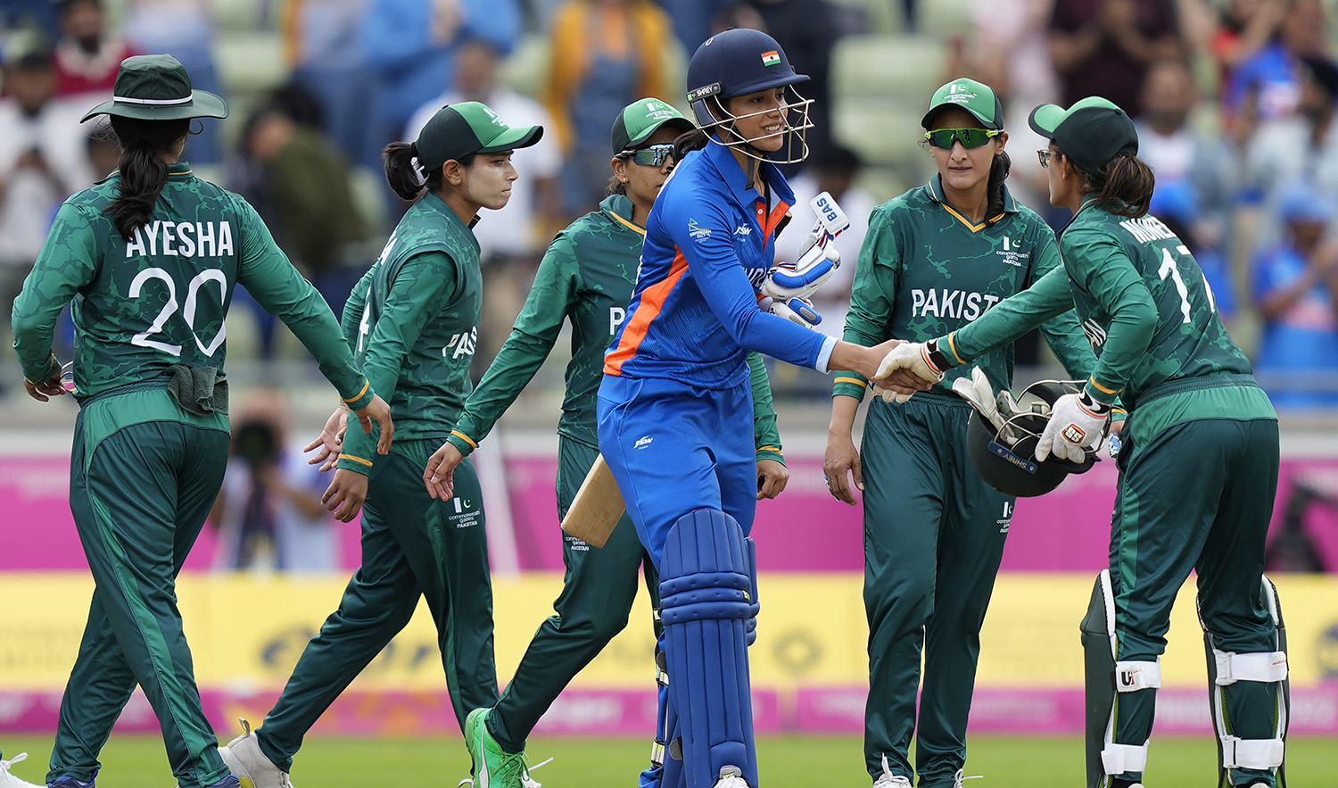 India's Smriti Mandhana, third right, shakes hands with Pakistan players after India won the women's cricket T20 preliminary round match against Pakistan at the Commonwealth Games in Birmingham, England, on July 31, 2022. (AP)