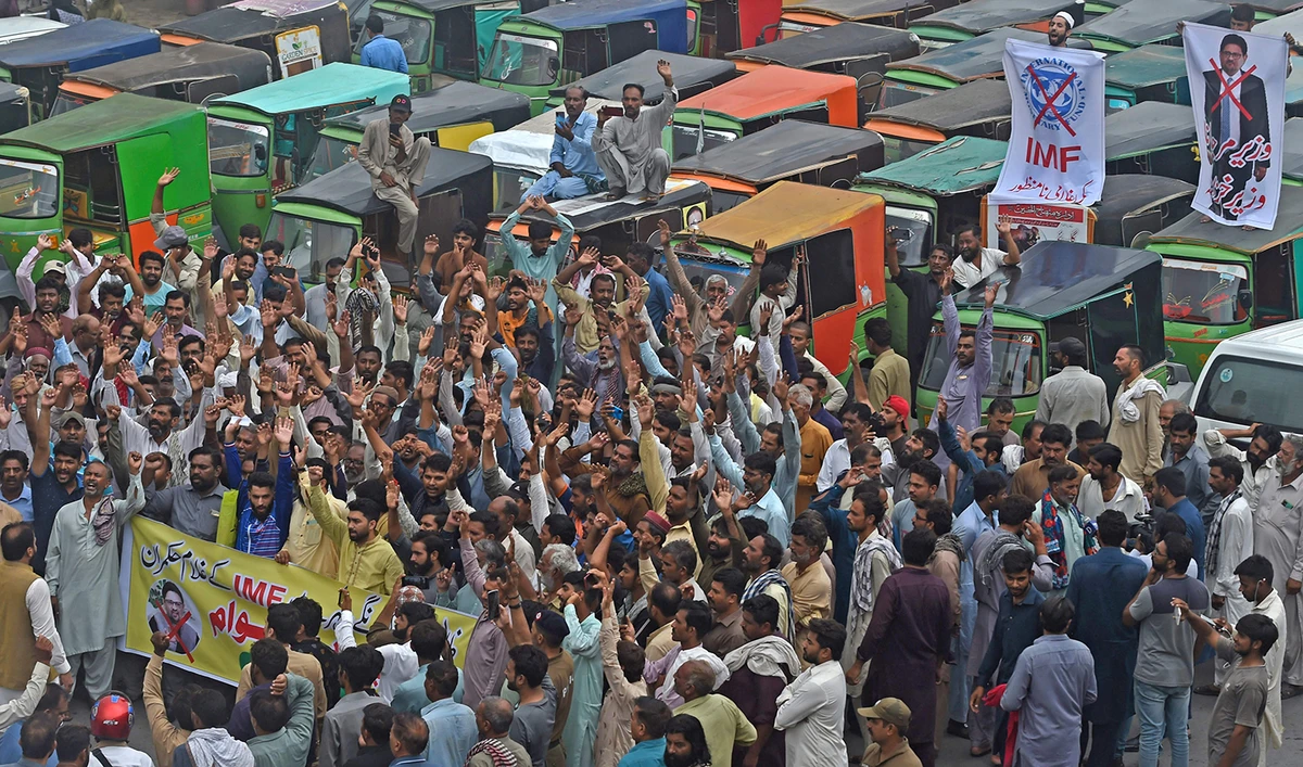 Autorickshaw drivers shout slogans as they protest against the rising fuel price during an anti-government demonstration in Lahore, Pakistan, on July 1, 2022. (AFP)