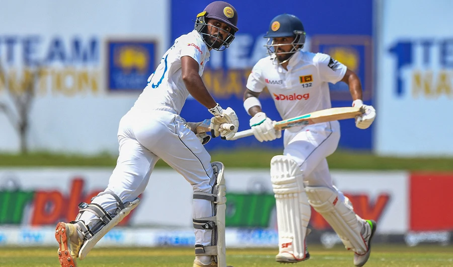 Sri Lanka's Kusal Mendis (R) and Oshada Fernando run between the wickets during the third day of play of the first cricket Test match between Sri Lanka and Pakistan in Galle on July 18, 2022. (AFP)