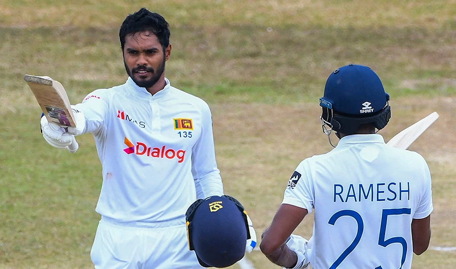 Sri Lanka's Dhananjaya de Silva (L) celebrates after scoring a century (100 runs) as his teammate Ramesh Mendis watches during the fourth day of the second cricket Test match between Sri Lanka and Pakistan in Galle on July 27, 2022. (AFP)