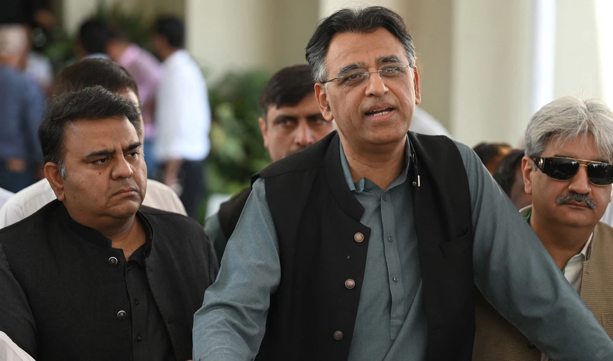 Laders of Pakistan Tehreek-e-Insaf Asad Umar (R) and Fawad Chaudhry (L) speak with the media outside the Supreme Court in Islamabad on April 6, 2022. (AFP/File)