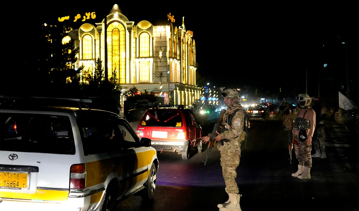 Taliban fighters stand guard at the site of an explosion in front of the Kabul International Cricket Stadium, in Kabul, Afghanistan, on July 29, 2022. (AP)
