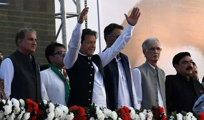 Pakistan's Prime Minister Imran Khan (C) along with other lawmakers, gestures upon his arrival to address the supporters of ruling Pakistan Tehreek-e-Insaf (PTI) party during a rally in Islamabad on March 27, 2022. (AFP/FILE)