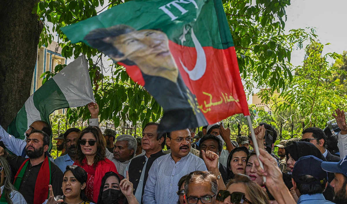 Supporters of former prime minister Imran Khan's Pakistan Tehreek-e-Insaf (PTI) party protest against the chief election commissioner, outside the Election Commission of Pakistan (ECP) office in Islamabad on April 26, 2022. (AFP/File)