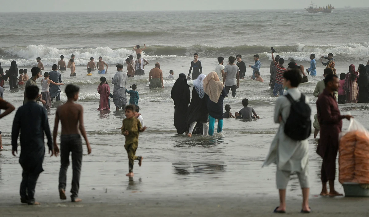People cool off at the Clifton beach in Karachi, Pakistan, on May 5, 2022. (AFP/File)