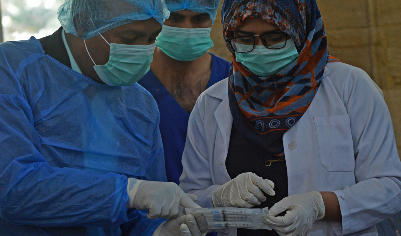 A doctor (L) and a paramedic attend a training session for the upcoming Covid-19 coronavirus vaccination drive in Karachi on January 30, 2021. (AFP/File)