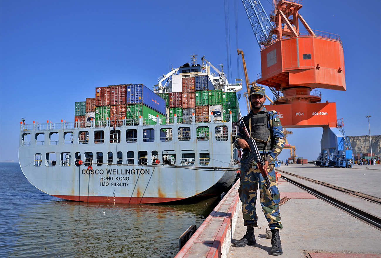 In this photograph taken on November 13, 2016, Pakistani Naval personnel stand guard near a ship carrying containers at the Gwadar port, some 700 kms west of Karachi. (AFP/File_